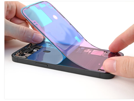 Continue peeling the back liner off the adhesive while pressing the adhesive into place along the edges of the iPhone's frame.