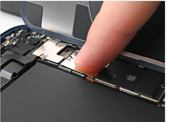 Use your finger to press the cover down on the logic board.